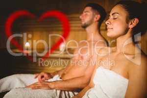 Composite image of happy couple enjoying the sauna together