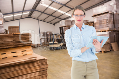 Composite image of businesswoman using tablet pc