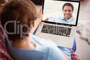 Composite image of pregnant woman using her laptop