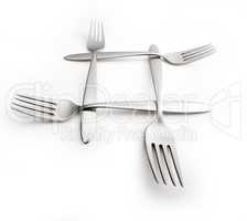 Four interlaced silver forks on wide background with wide angle