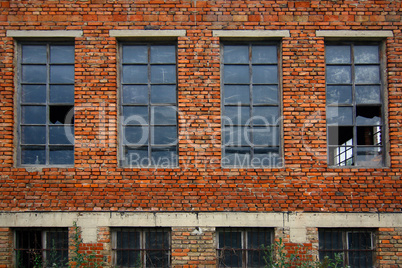Old brick wall with broken windows