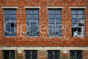 Old brick wall with broken windows