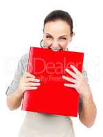 business woman bites in a red binder