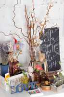 Decoration tools with flowers and bottles on white wooden backgr