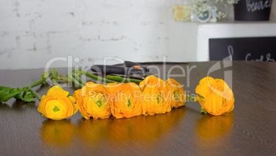Bright orange flowers on dark wooden table