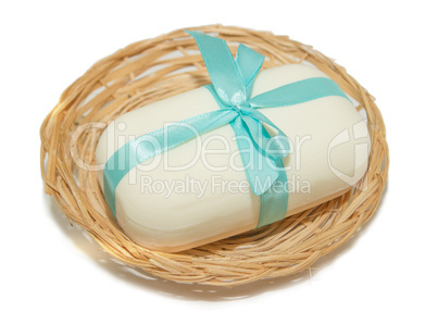 isolation photo of soap with a bow in a basket on a white backgr