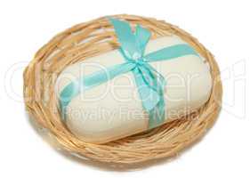 isolation photo of soap with a bow in a basket on a white backgr