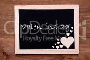 Blackboard With Wooden Hearts, Text Valentinstag Means Valentines Day