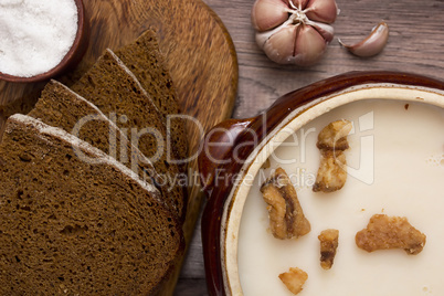 Melted fat and brown bread on chopping board