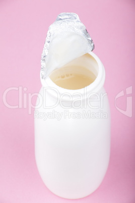 white bottle on pink background