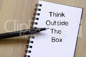 Think outside the box write on notebook