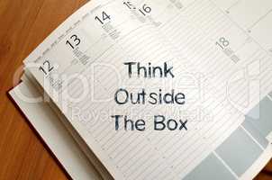 Think outside the box write on notebook