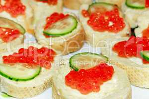 sandwiches with red caviar and piece of cucumber