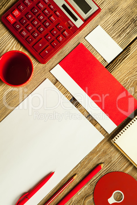 The mockup on wooden background with red calculator