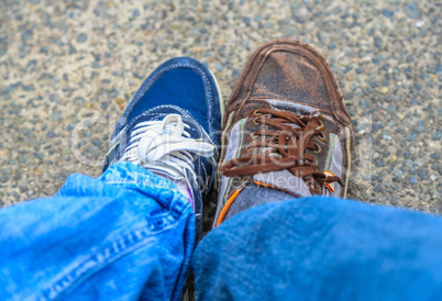 male and female shoe on the pavement