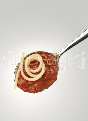 Spaghetti and bolognese sauce on a spoon