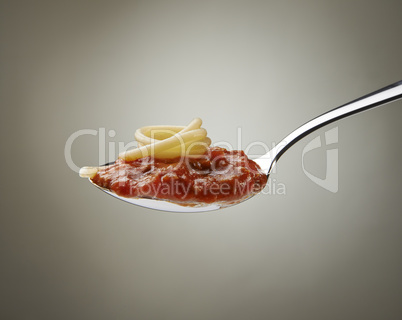 Spaghetti and bolognese sauce on a spoon