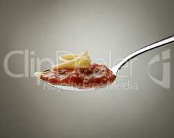 Spaghetti and bolognese sauce on a spoon