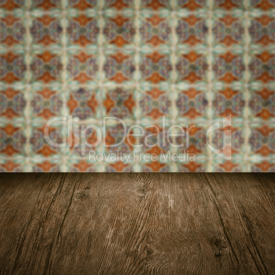 Wood table top and blur vintage ceramic tile pattern wall