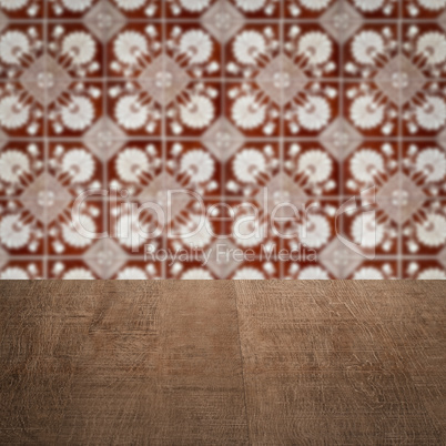 Wood table top and blur vintage ceramic tile pattern wall