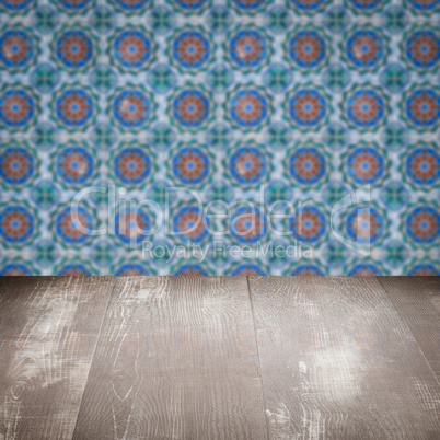 Wood table top and blur vintage ceramic tile pattern wall