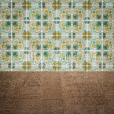 Wood table top and blur vintage ceramic tile pattern wall Wood table top and blur vintage ceramic tile pattern wall