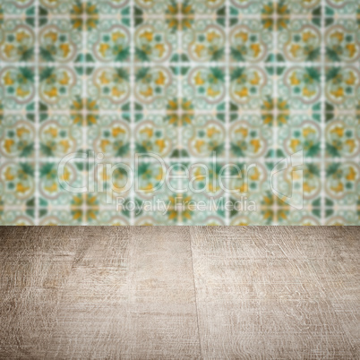 Wood table top and blur vintage ceramic tile pattern wall