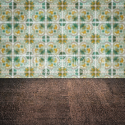 Wood table top and blur vintage ceramic tile pattern wall