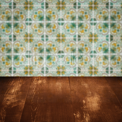 Wood table top and blur vintage ceramic tile pattern wall