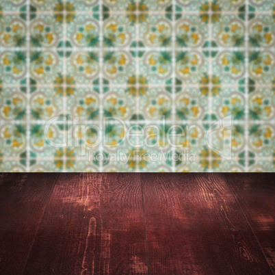 Wood table top and blur vintage ceramic tile pattern wall