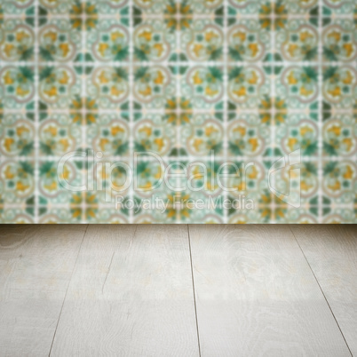 Wood table top and blur vintage ceramic tile pattern wall