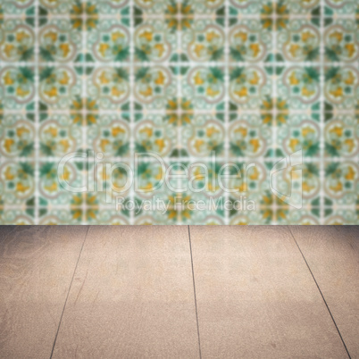 Wood table top and blur vintage ceramic tile pattern wall