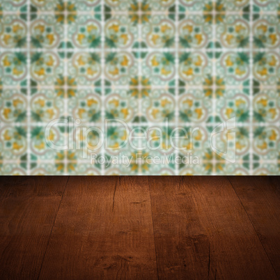 Wood table top and blur vintage ceramic tile pattern wall