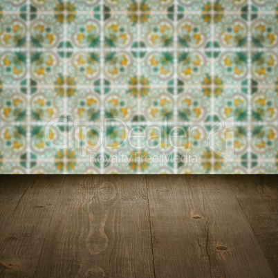 Wood table top and blur vintage ceramic tile pattern wall