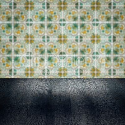 Wood table top and blur vintage ceramic tile pattern wall Wood table top and blur vintage ceramic tile pattern wall