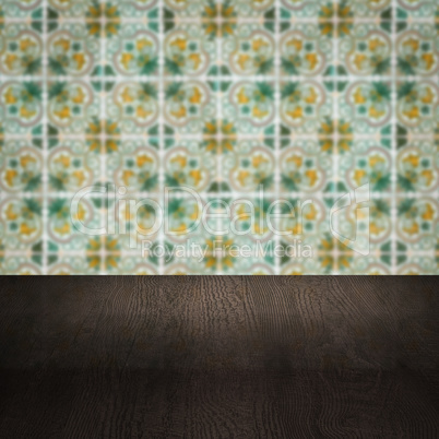 Wood table top and blur vintage ceramic tile pattern wall