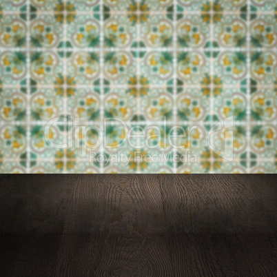 Wood table top and blur vintage ceramic tile pattern wall