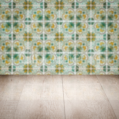 Wood table top and blur vintage ceramic tile pattern wall