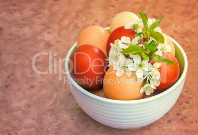 Easter eggs on the table in a ceramic vase.