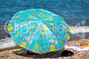 Sunshades and clothes on a sea beach