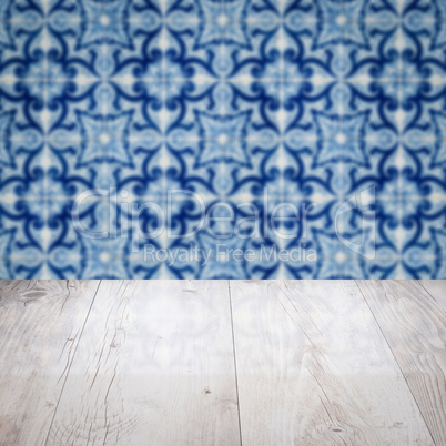 Wood table top and blur vintage ceramic tile pattern wall