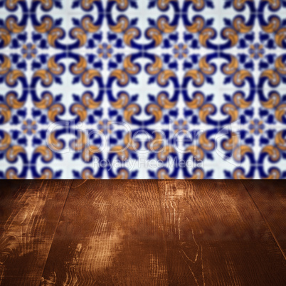 Wood table top and blur vintage ceramic tile pattern wall