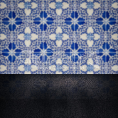 Wood table top and blur vintage ceramic tile pattern wall