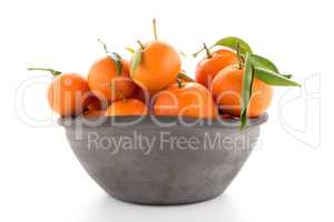 Tangerines on clay bowl