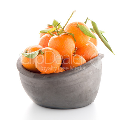 Tangerines on clay bowl