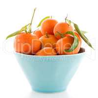 Tangerines on ceramic blue bowl