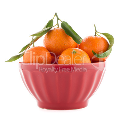 Tangerines on ceramic red bowl