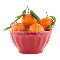 Tangerines on ceramic red bowl