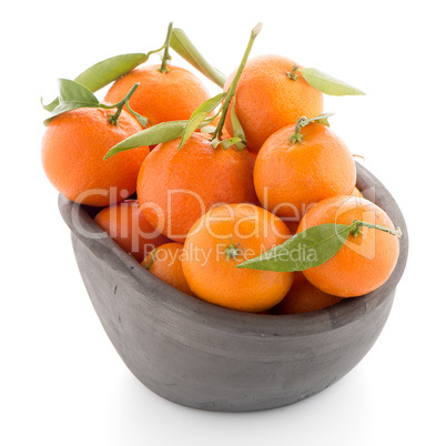 Tangerines on clay bowl