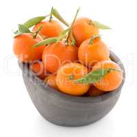 Tangerines on clay bowl